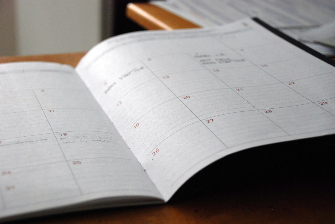 An open monthly planner on a desk – How to Create Custom Homeschool Planner Pages