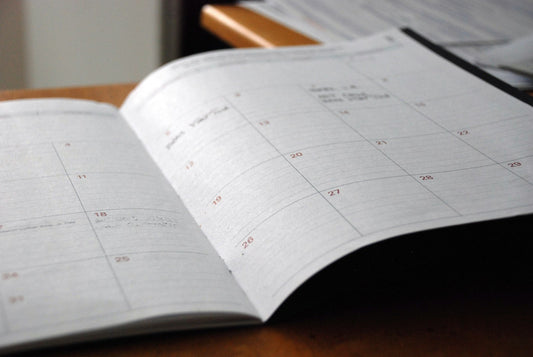 An open monthly planner on a desk – How to Create Custom Homeschool Planner Pages