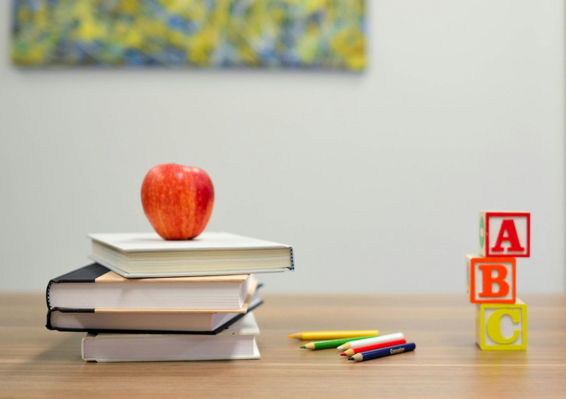 An apple on a stack of school books – Best Books for High School Homeschool Students