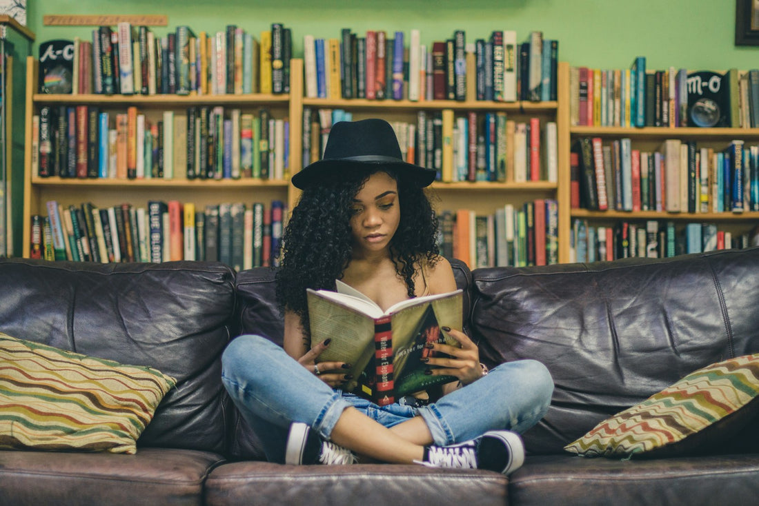 A young woman reading on a couch – Best Books for Teens