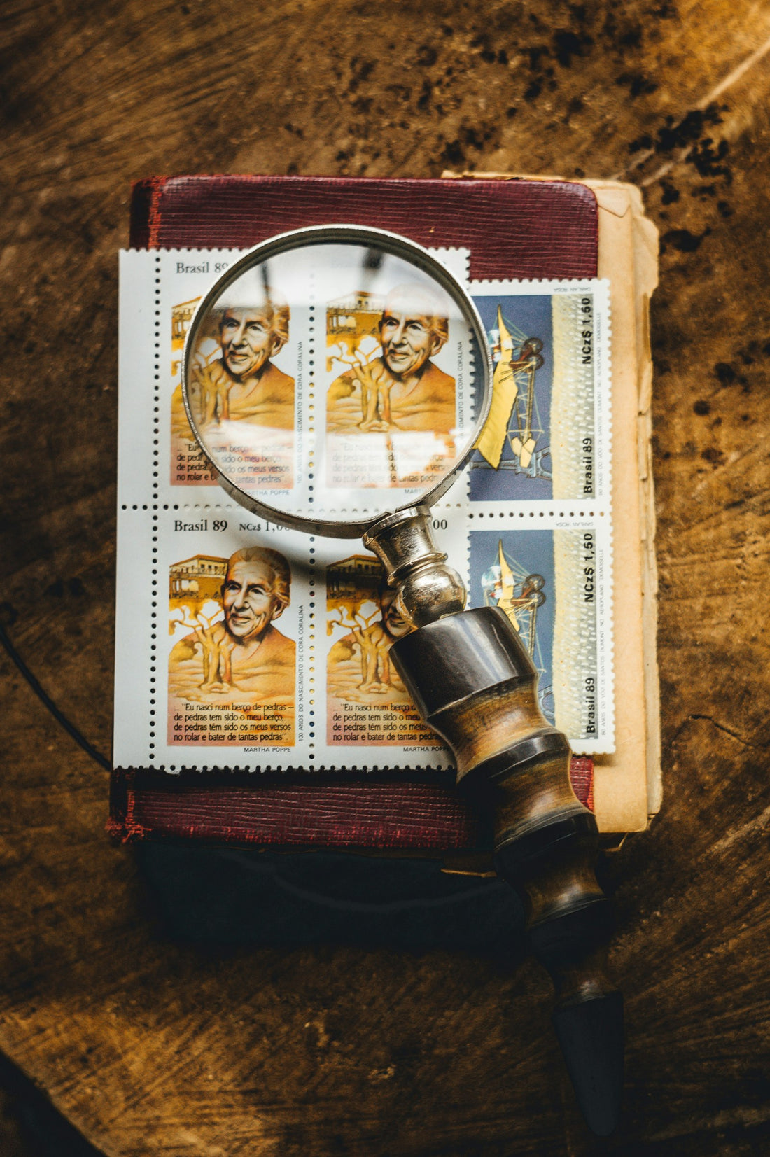 A silver magnifying glass resting on a book – Arthur Conan Doyle Books in Order
