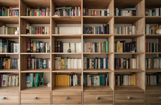 Books on a wooden bookshelf – Books Every Home Library Should Have