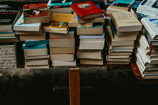 A pile of used books on a table – Affordable Books for Families