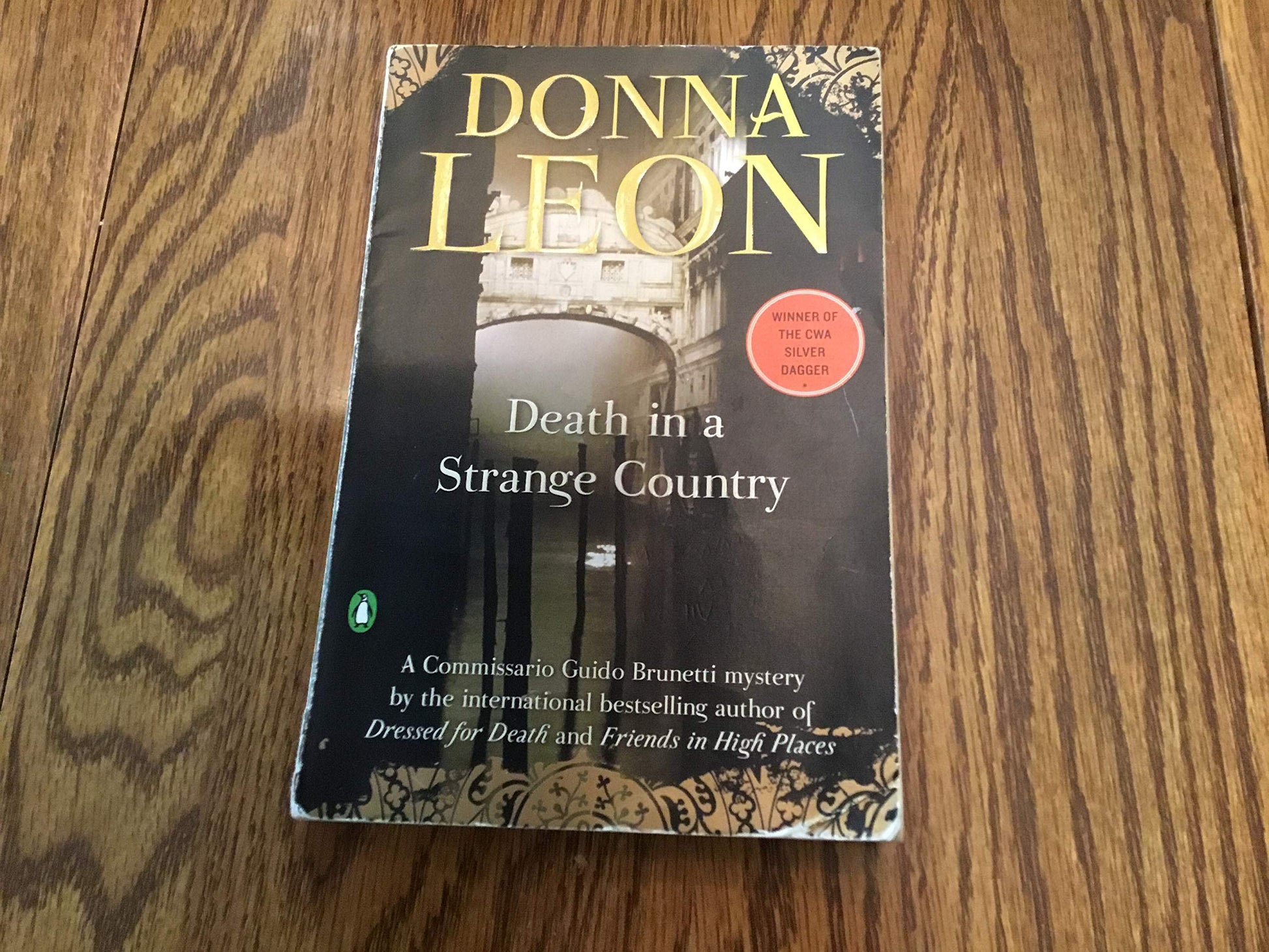 Death in a Strange Country: A Commissario Guido Brunetti Mystery The Happy Book Stack
